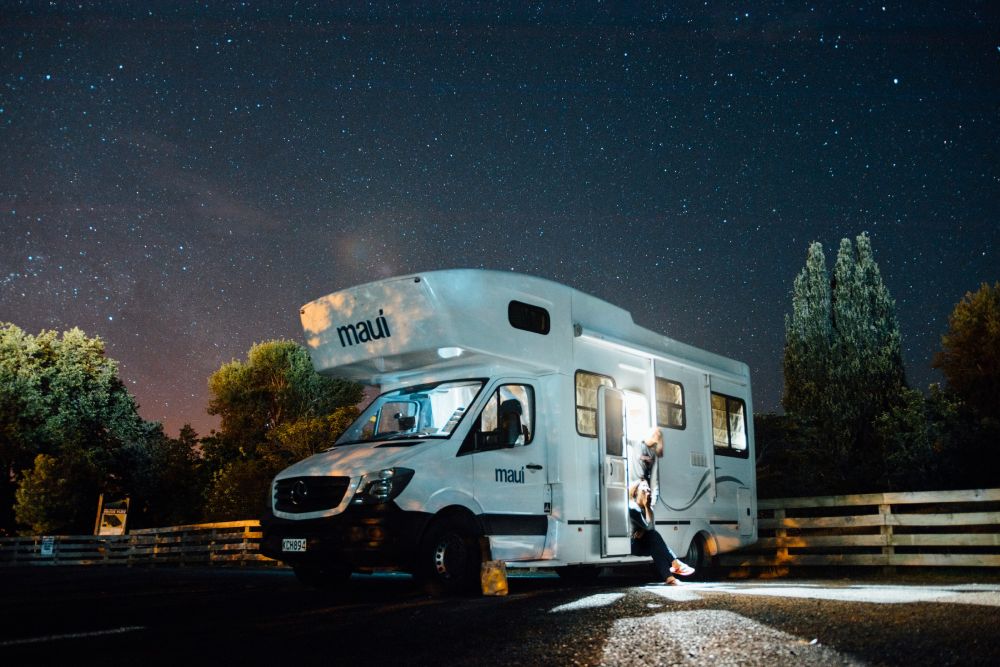 A motorhome parked up at night under the stars