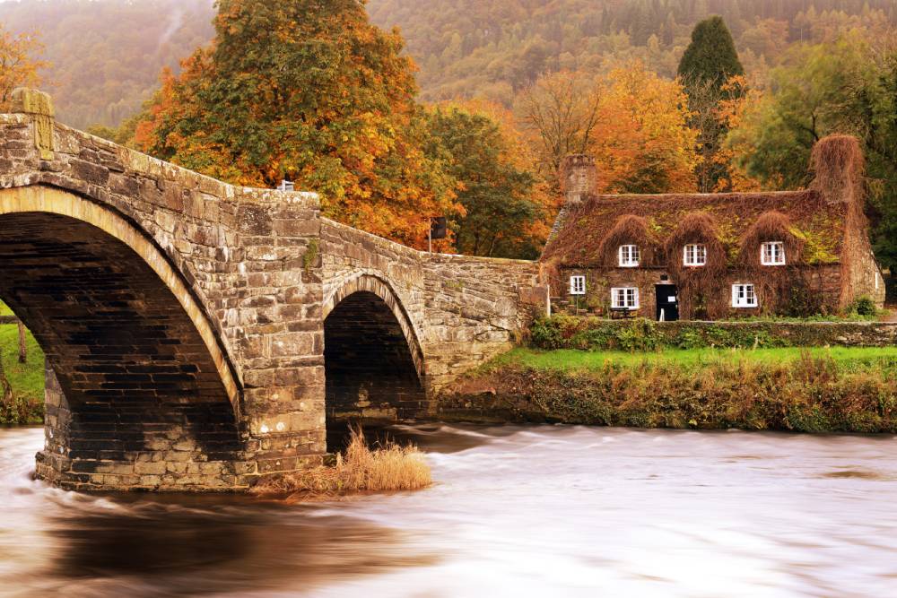 A stone bridge over a river in Wales